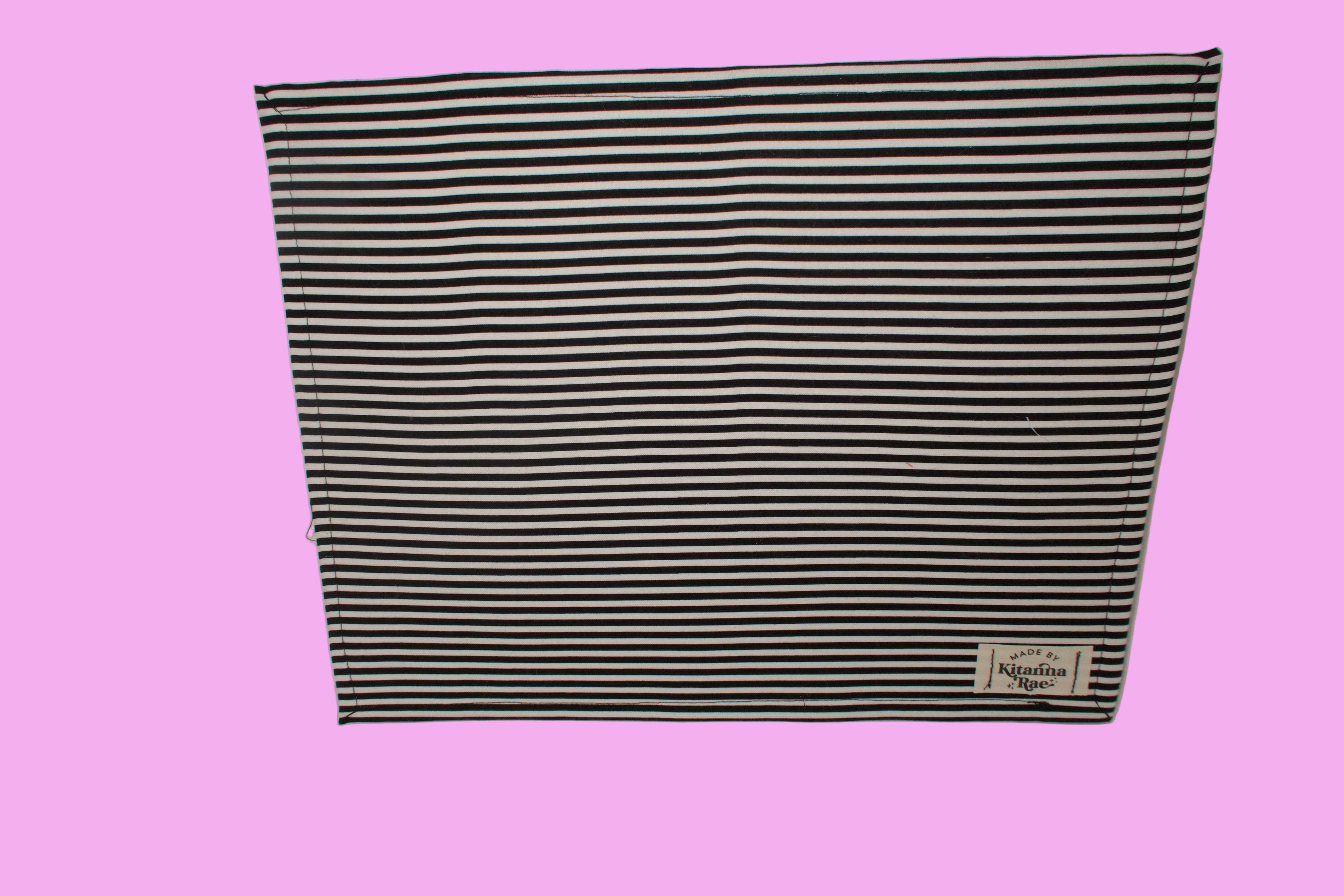 Black and white striped fabric with a brand label on a white background