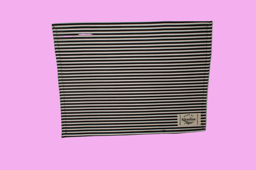 Black and white striped fabric with a brand logo on a white background