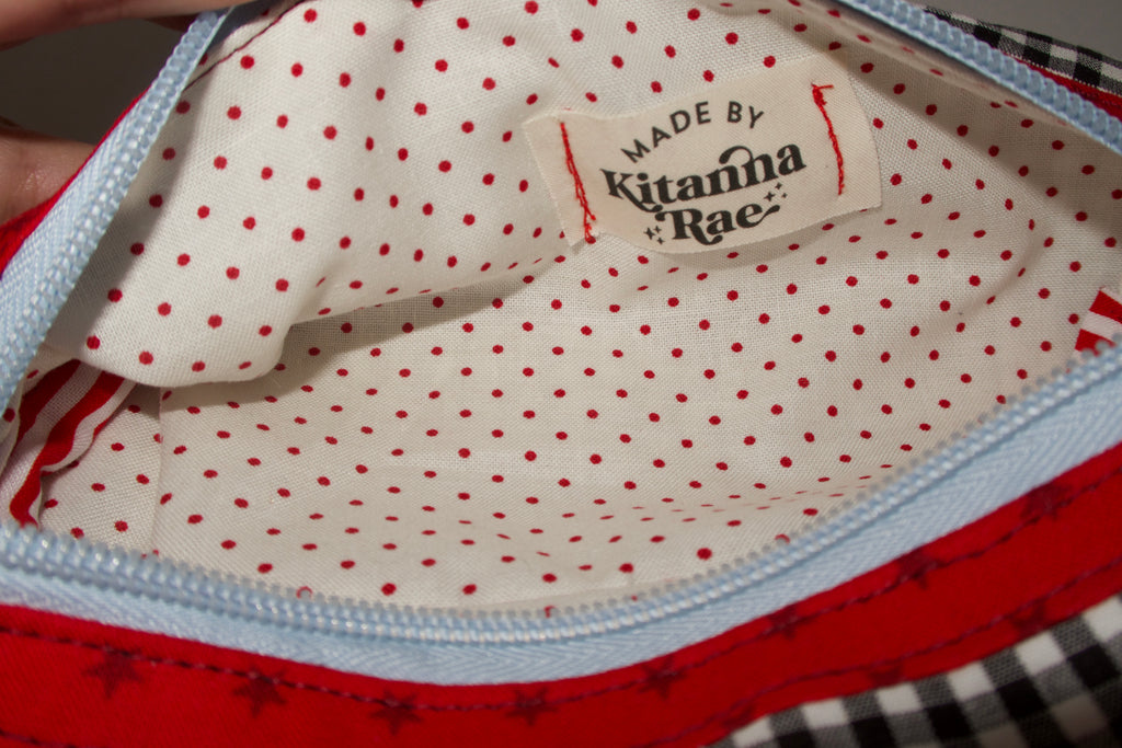 Close-up of a polka dot fabric with a 'Made by Kitana Rae' label.