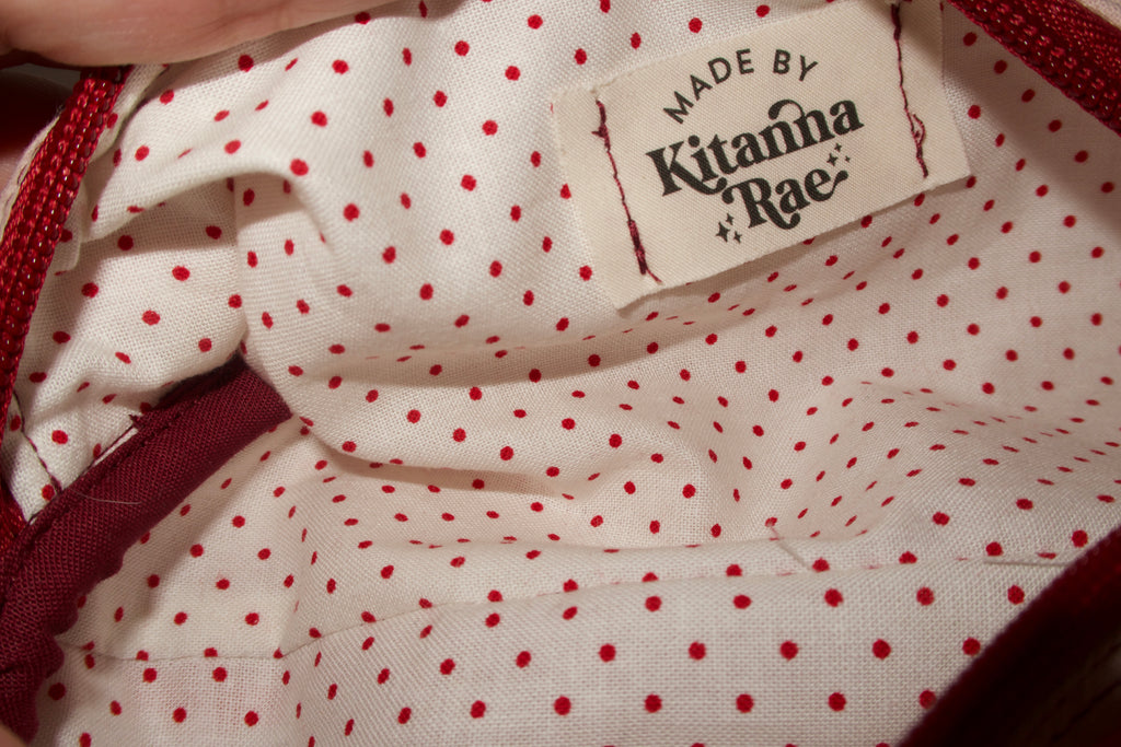 Close-up of a garment with a 'Made by Kitanna Rae' label.