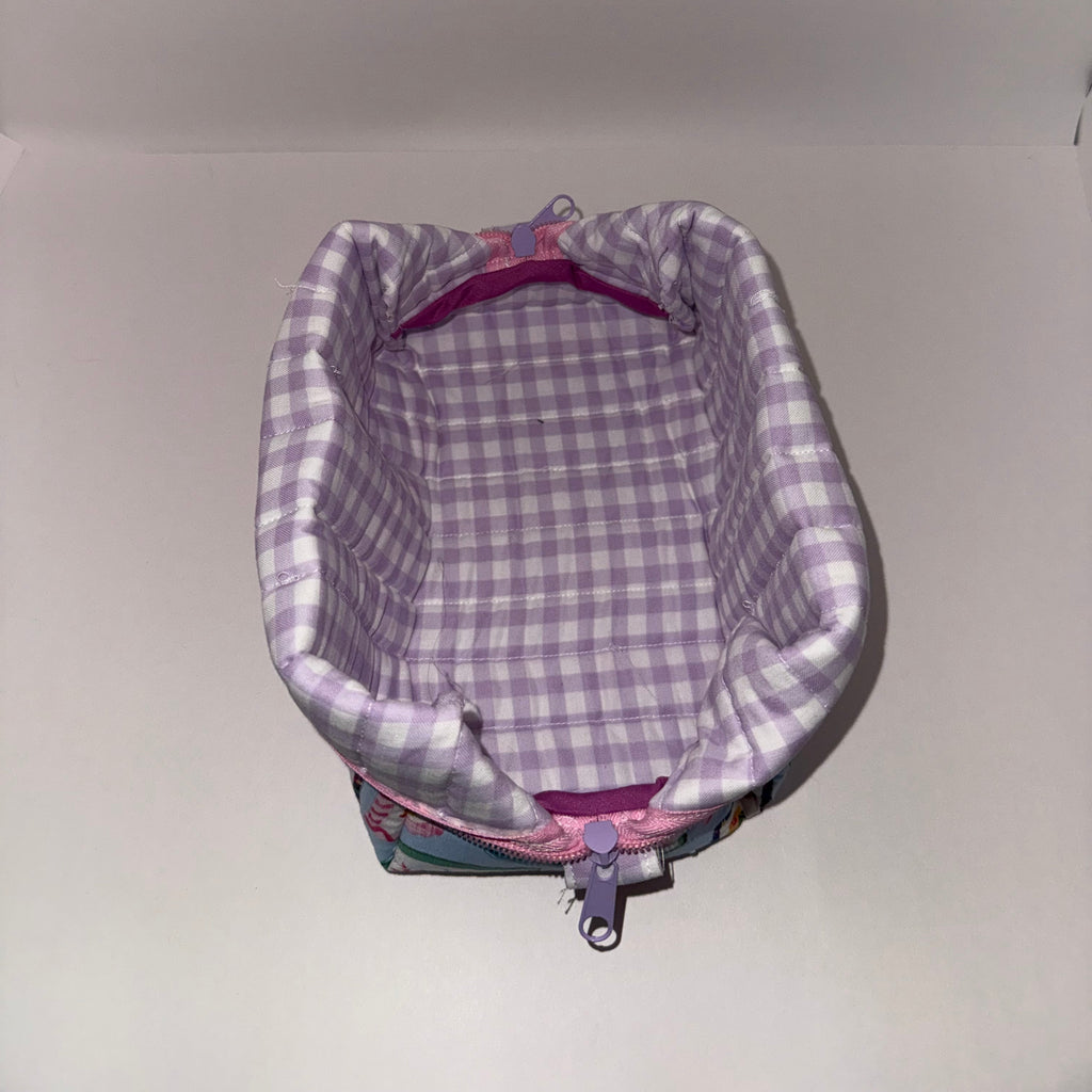 Backpack with purple and gray checkered interior on a plain background