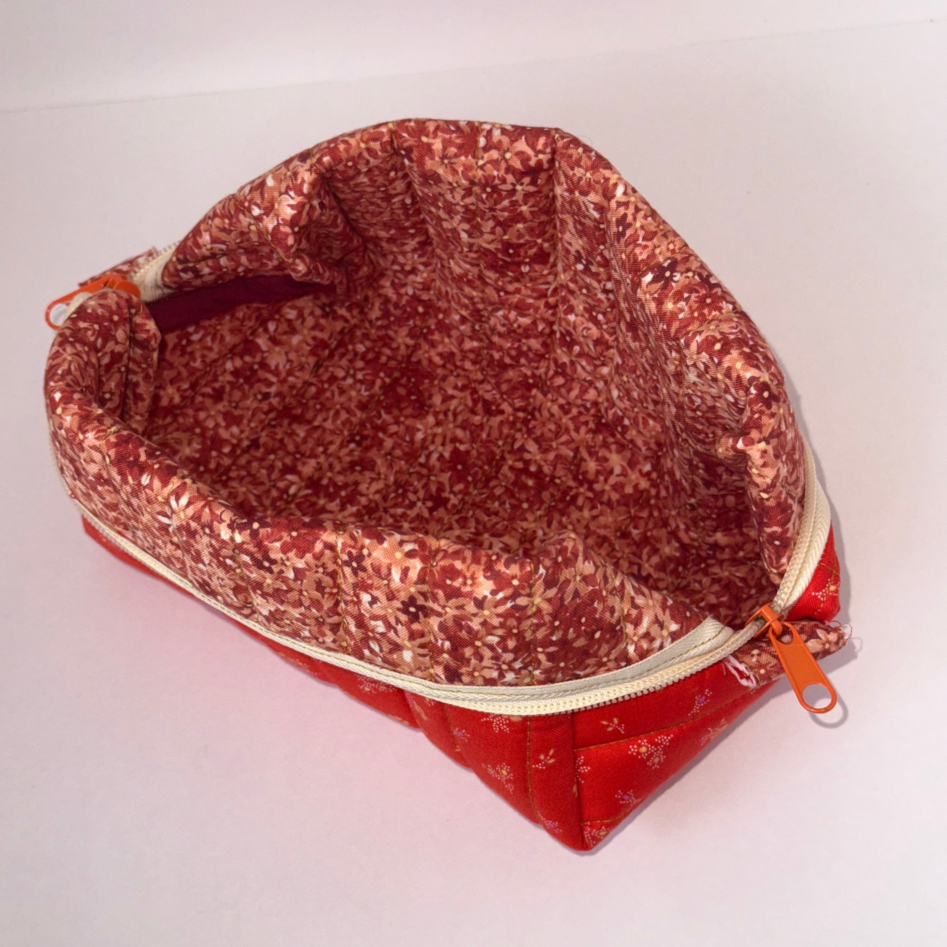 Glittery red pouch with a zipper on a white background